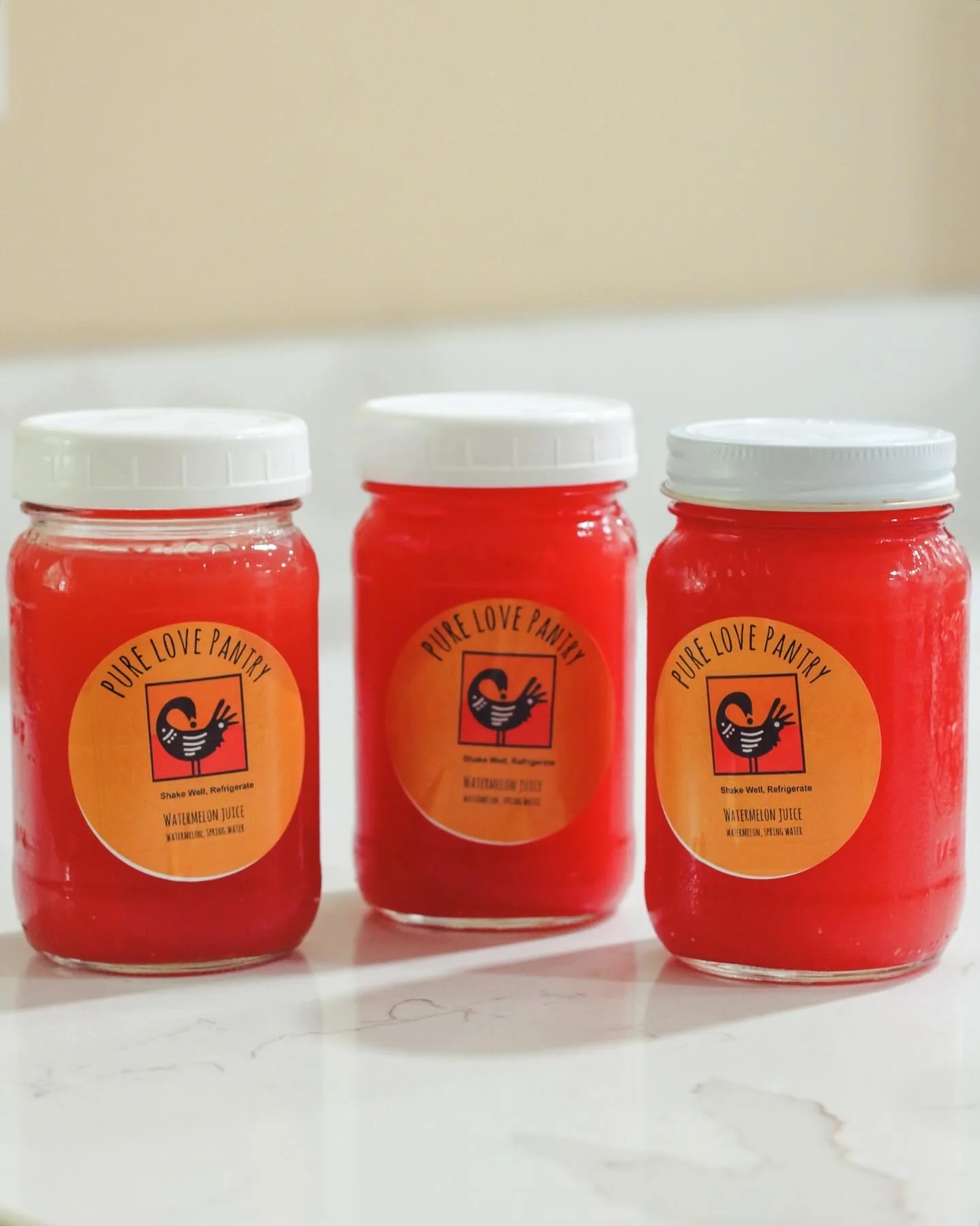 Three jars of Pure Love Pantry watermelon juice