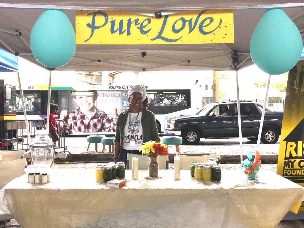 Pure Love Pantry market booth with juices and wellness products