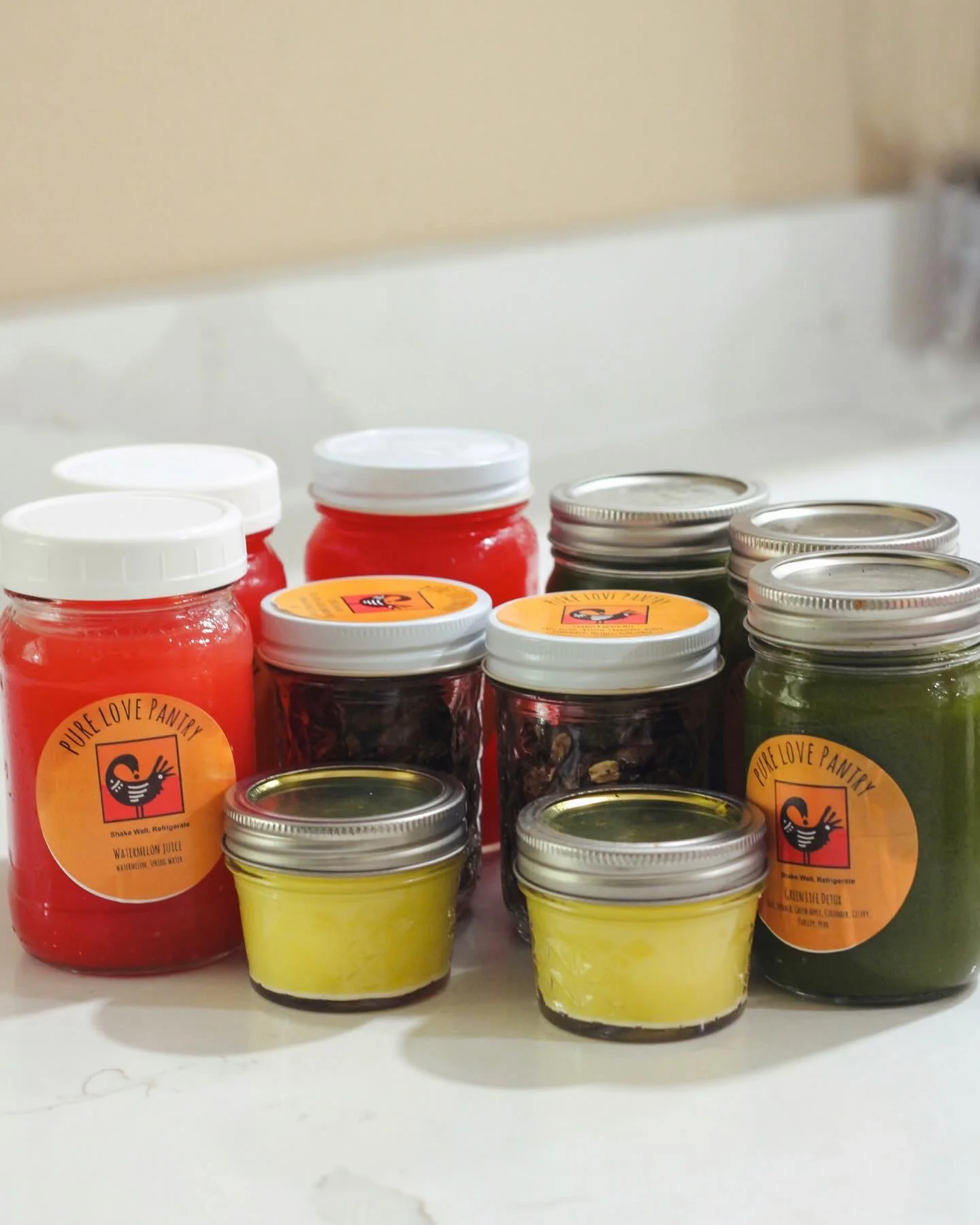 A colorful assortment of Pure Love Pantry juices, tonics, and snacks