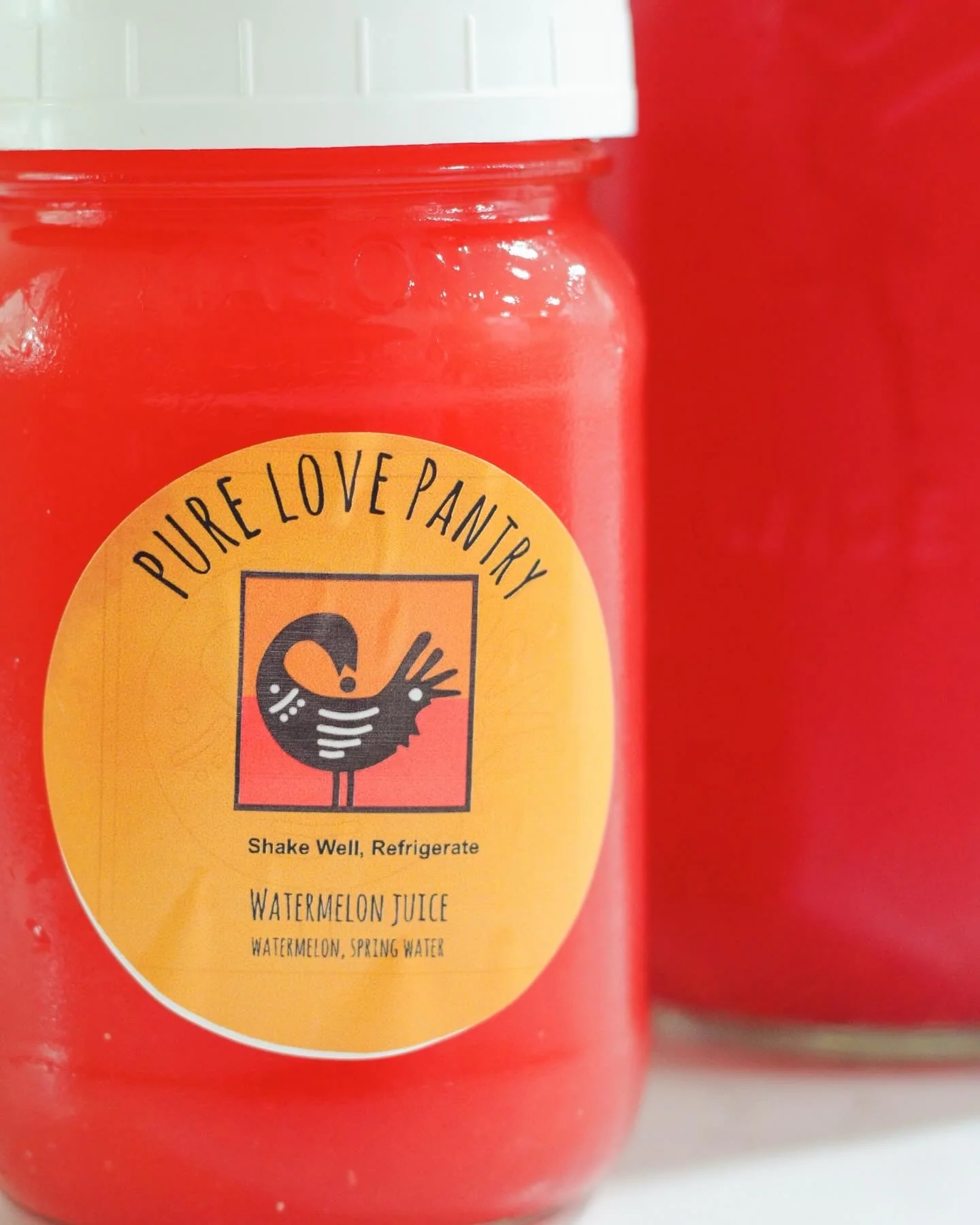 Close-up of a Pure Love Pantry watermelon juice jar