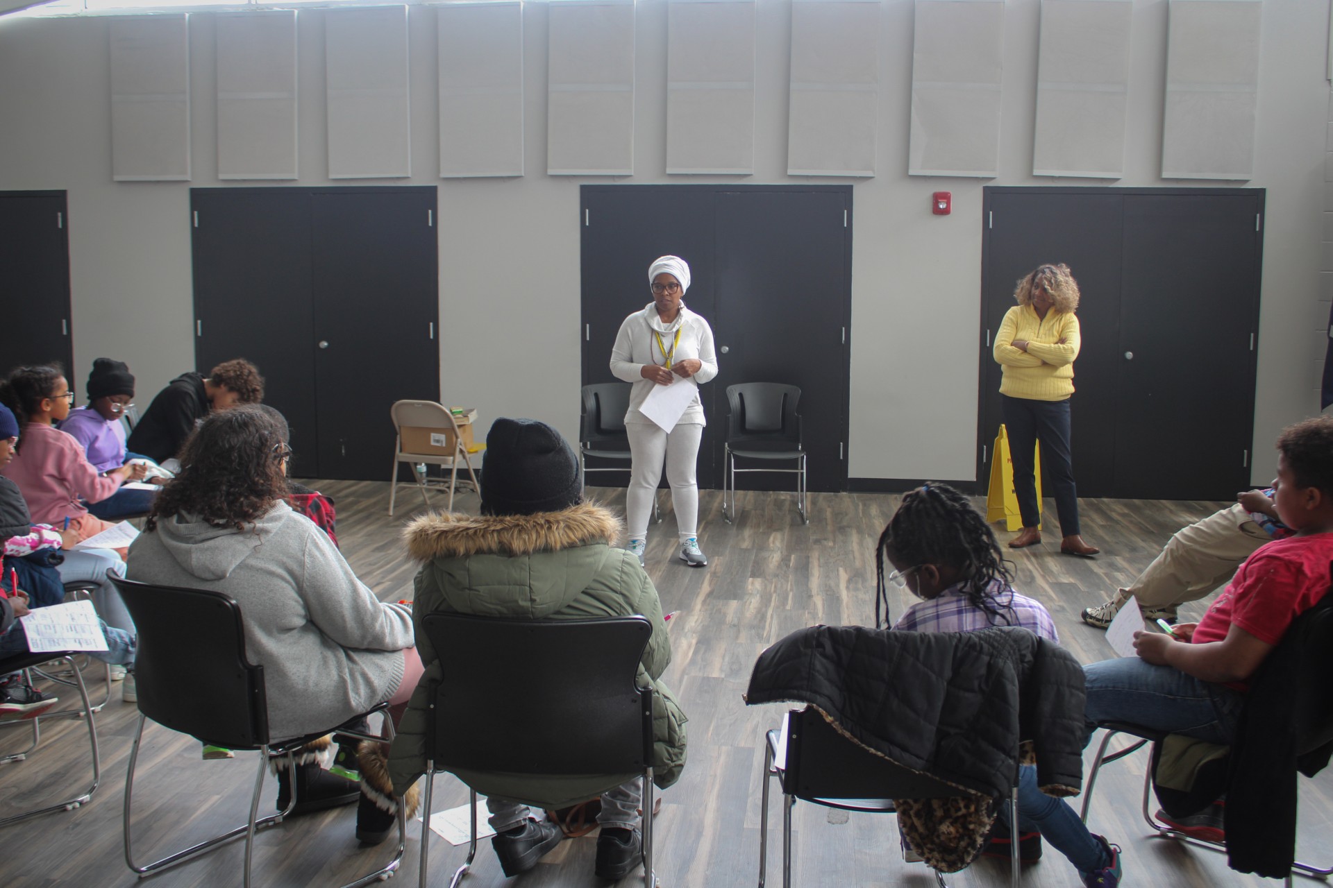 Wendy Firven leading a community wellness workshop with participants gathered in a circle