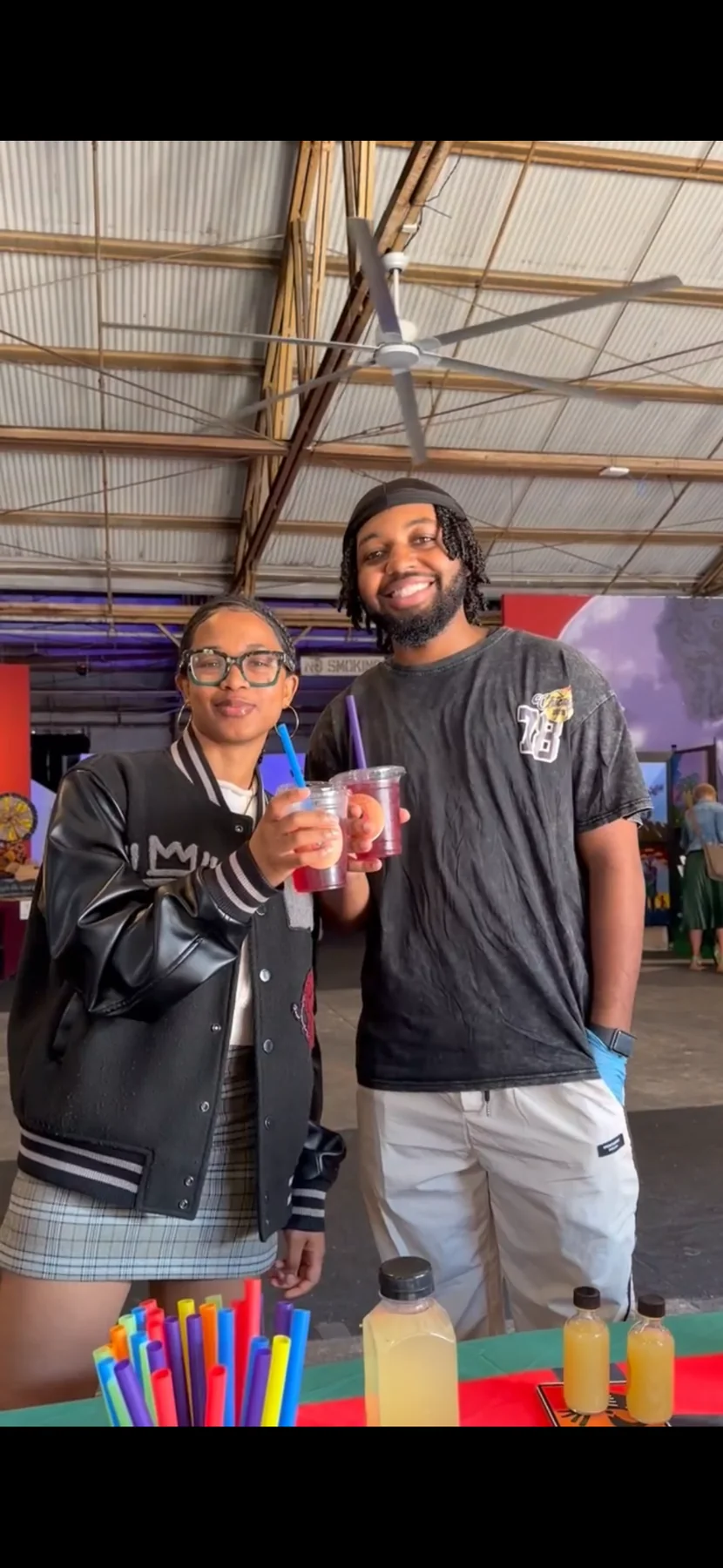 Two guests enjoying Pure Love Pantry drinks at a community event