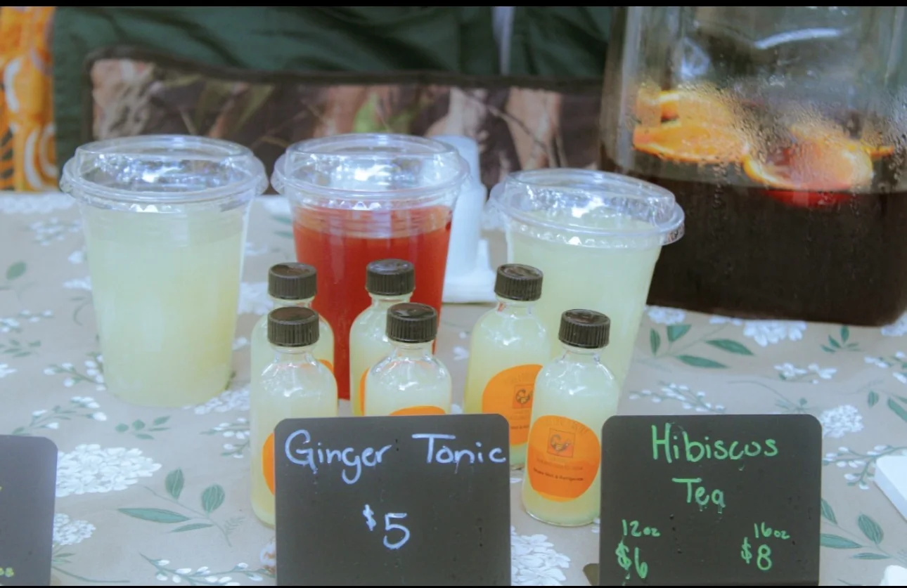 Ginger tonic and hibiscus tea displayed at a Pure Love Pantry booth