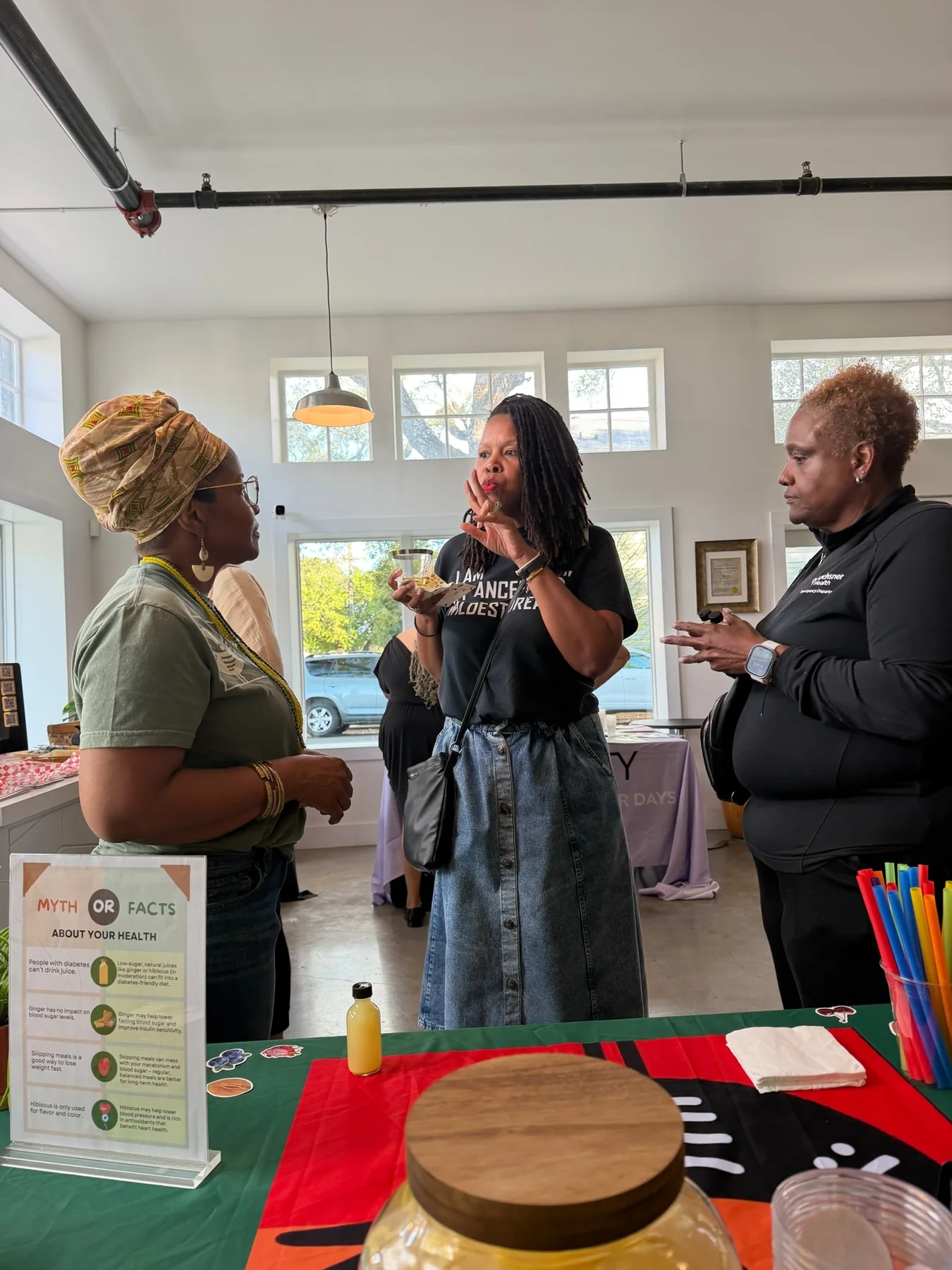 Wendy Firven speaking with guests during a wellness event