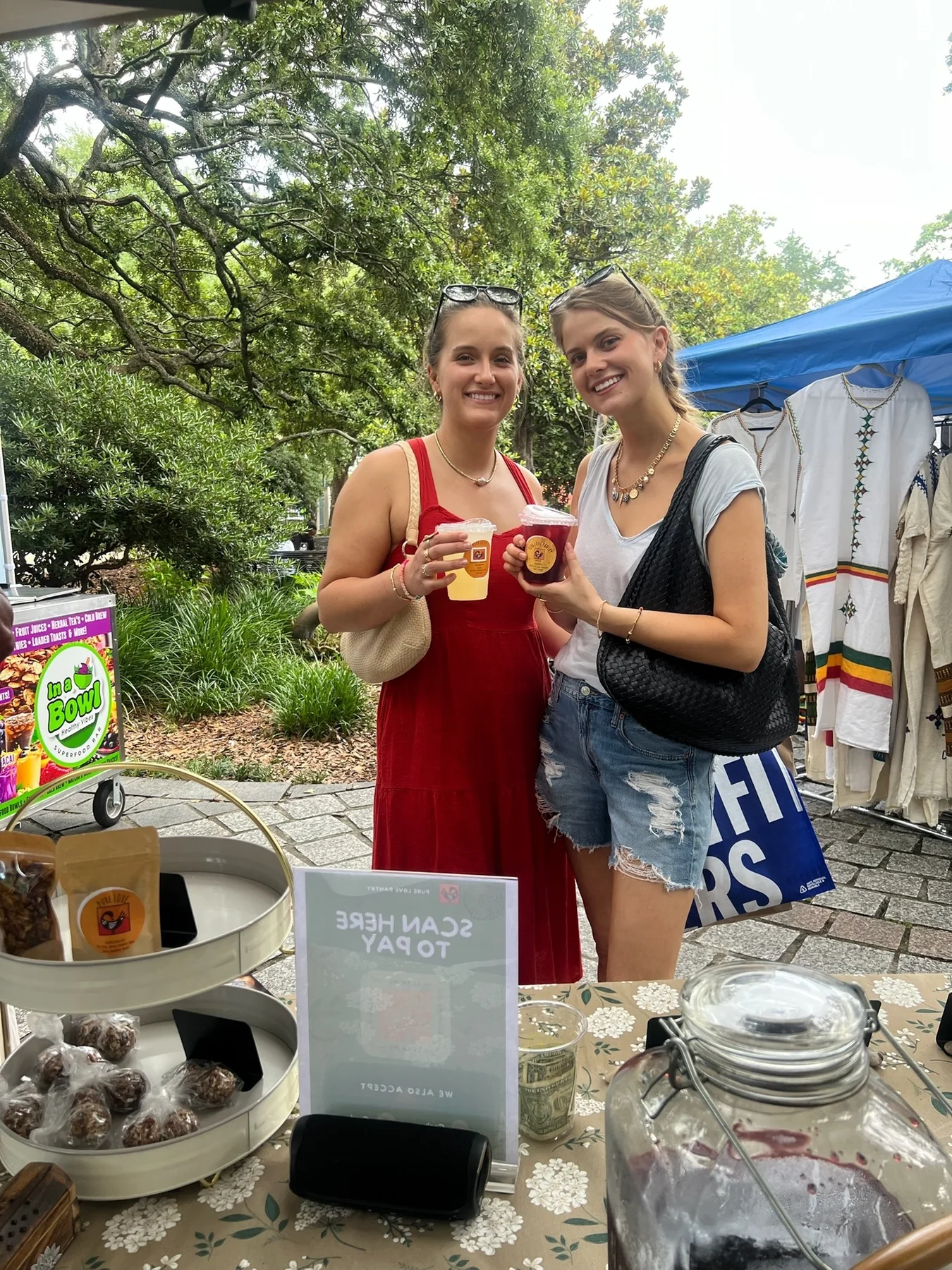 Two guests holding colorful Pure Love Pantry beverages