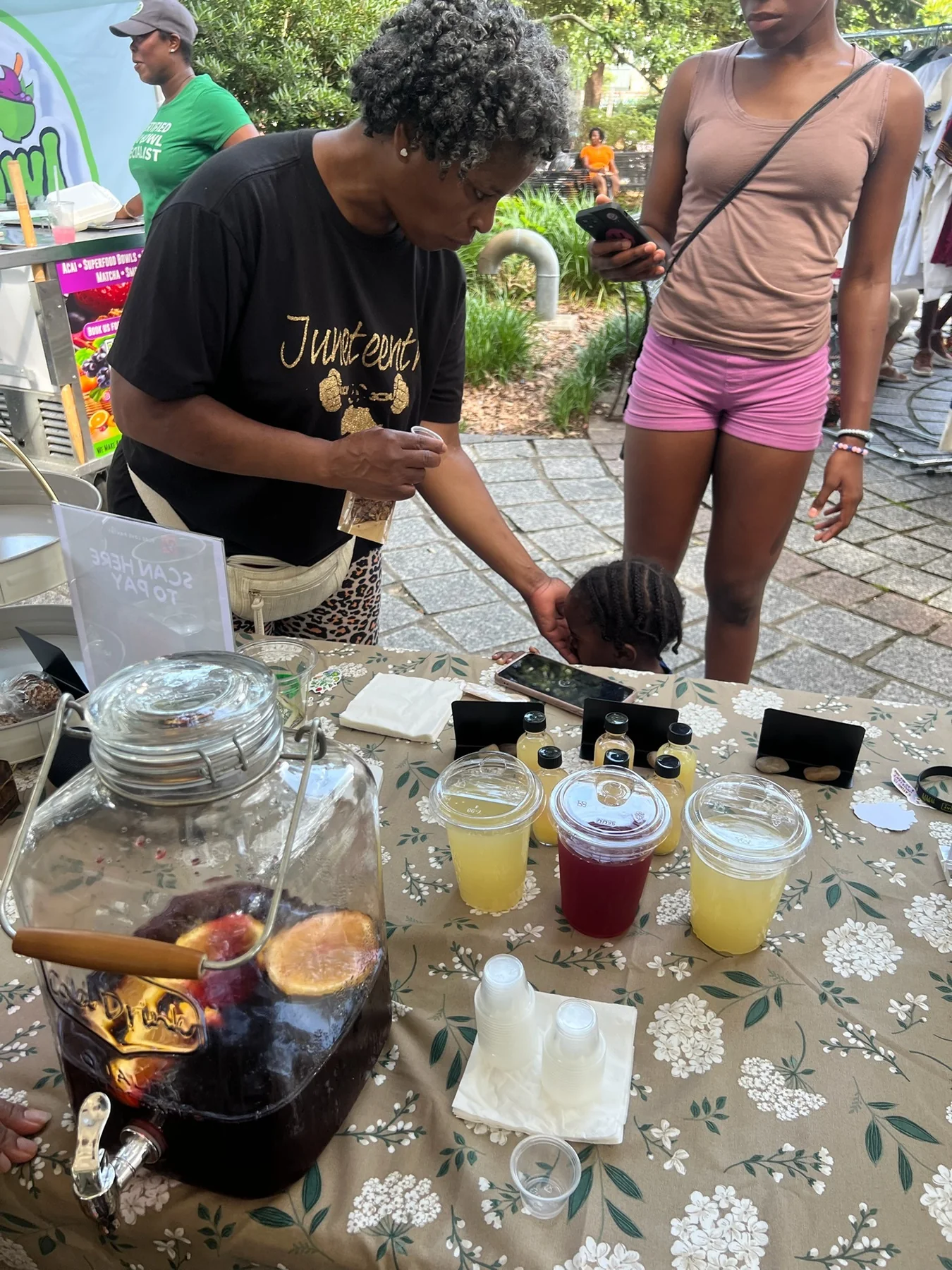 A family visiting the Pure Love Pantry booth