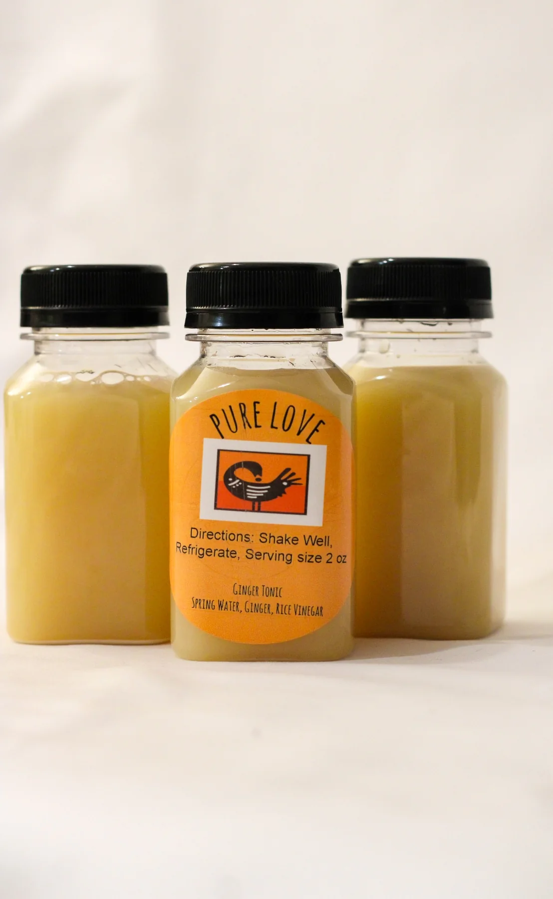 Three bottles of Pure Love Pantry ginger tonic